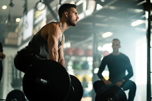 man weightlifting barbell at gym